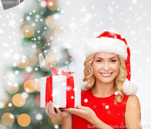 Image of smiling woman in red dress with gift box