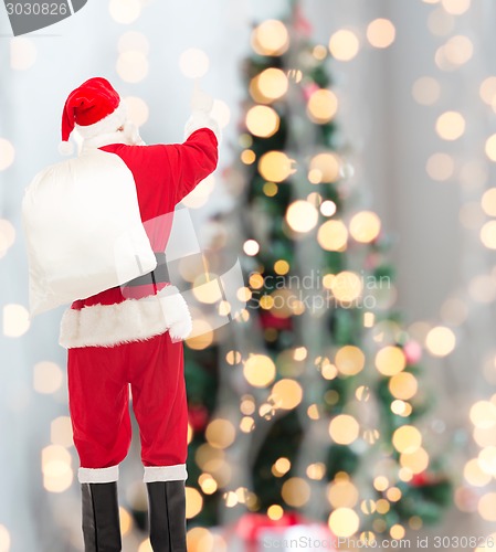 Image of man in costume of santa claus with bag