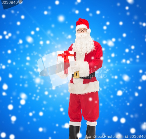 Image of man in costume of santa claus with gift box