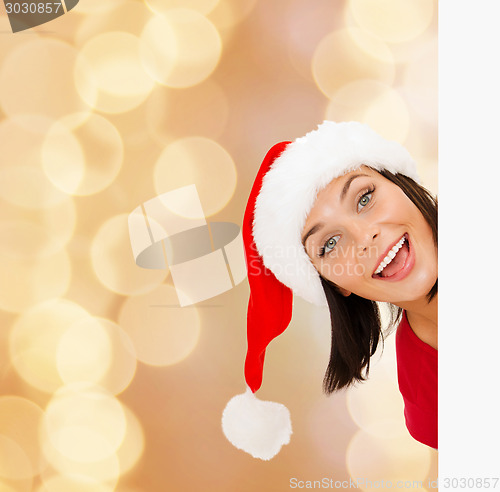 Image of woman in santa helper hat with blank white board