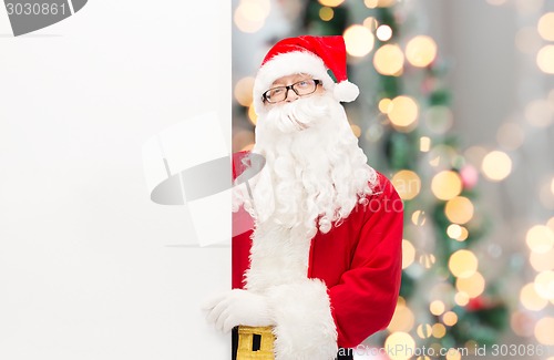 Image of man in costume of santa claus with billboard