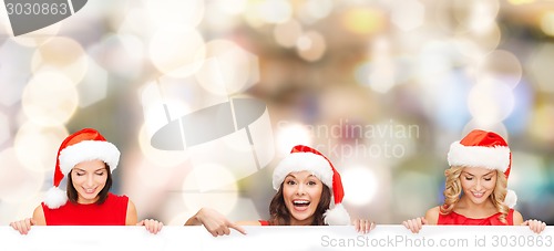 Image of women in santa helper hat with blank white board