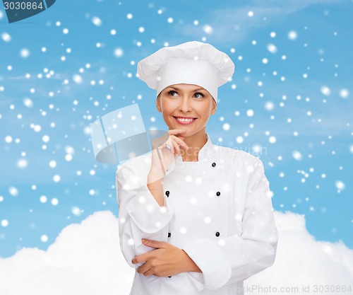 Image of smiling female chef dreaming