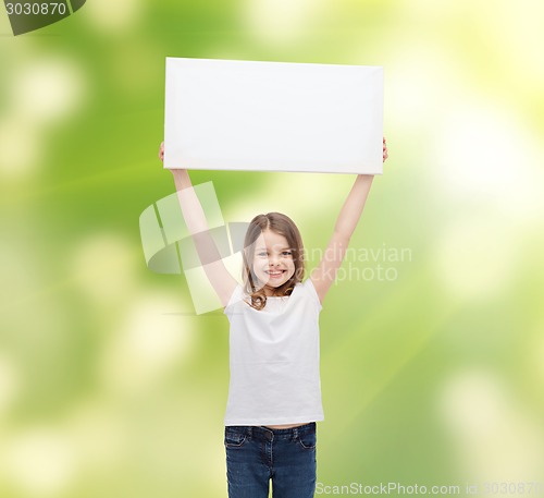 Image of smiling little girl holding blank white board
