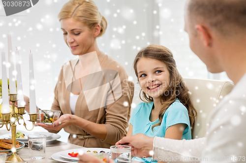 Image of smiling family having holiday dinner at home