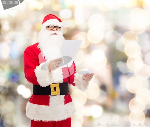 Image of man in costume of santa claus with letter