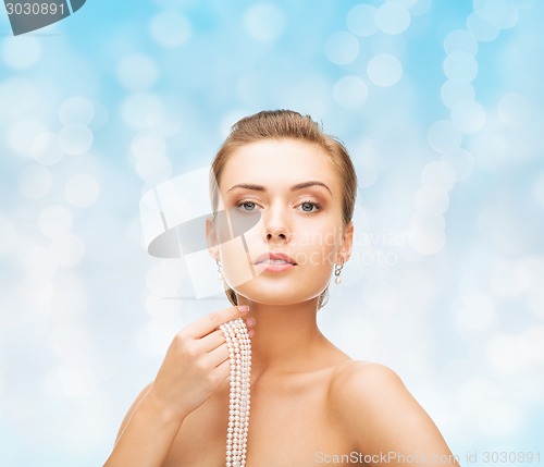 Image of beautiful woman with pearl earrings and bracelet