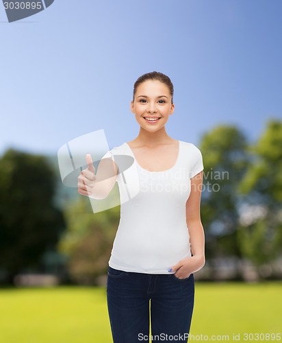 Image of smiling young woman in blank white t-shirt