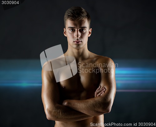 Image of young male bodybuilder with bare muscular torso