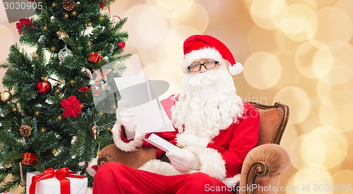 Image of man in costume of santa claus with letter