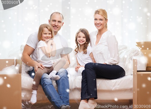 Image of smiling parents and two little girls at new home