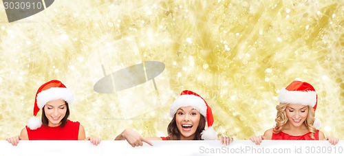 Image of women in santa helper hat with blank white board