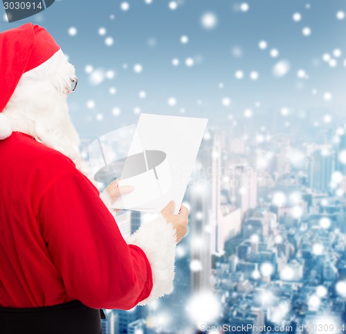 Image of man in costume of santa claus with letter