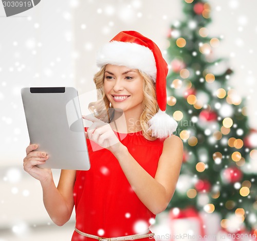 Image of woman in santa helper hat with tablet pc