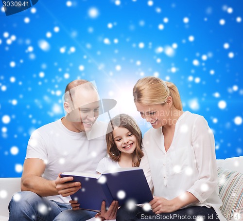 Image of happy family with book at home