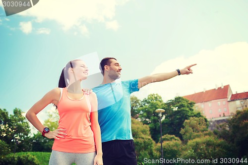 Image of two smiling people outdoors