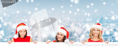 Image of women in santa helper hat with blank white board