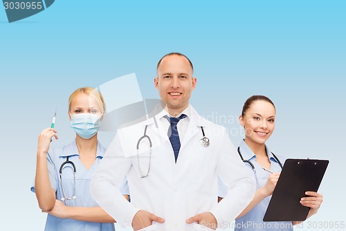 Image of group of smiling doctors with clipboard