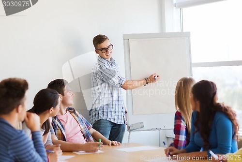 Image of group of smiling students with white board