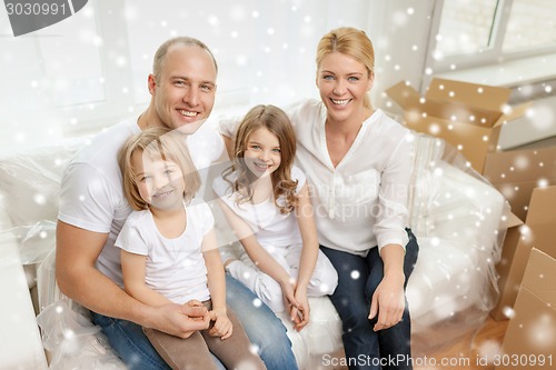 Image of smiling parents and two little girls at new home