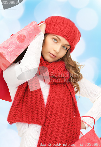 Image of smiling young woman with shopping bags