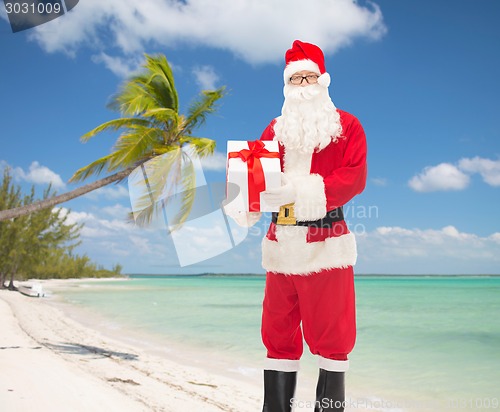 Image of man in costume of santa claus with gift box