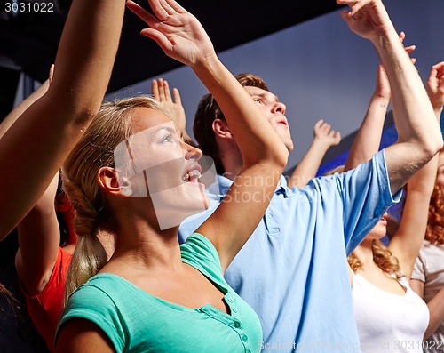 Image of smiling friends at concert in club