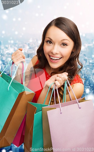 Image of smiling woman with colorful shopping bags