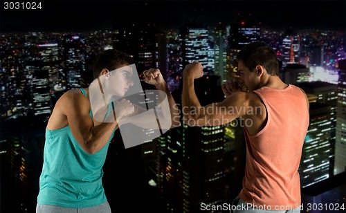 Image of young men fighting hand-to-hand