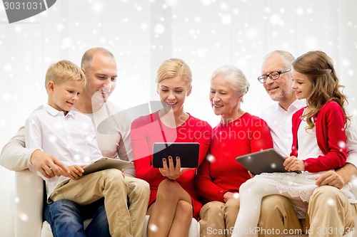 Image of smiling family with tablet pc computers at home