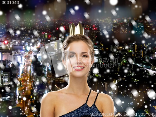 Image of smiling woman in evening dress wearing crown