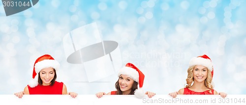 Image of women in santa helper hat with blank white board