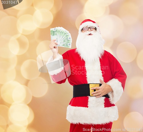 Image of man in costume of santa claus with euro money