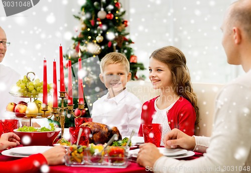 Image of smiling family having holiday dinner at home