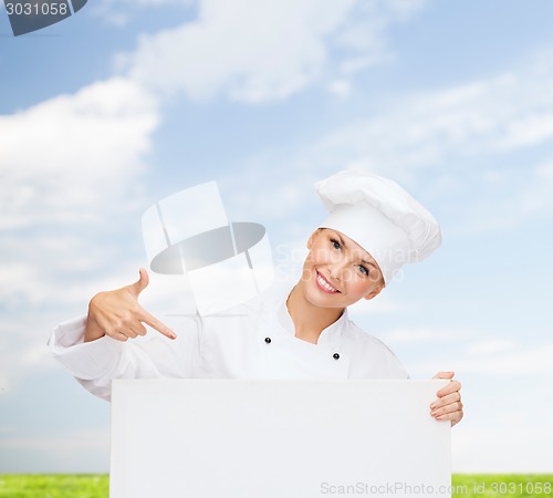 Image of smiling female chef with white blank board