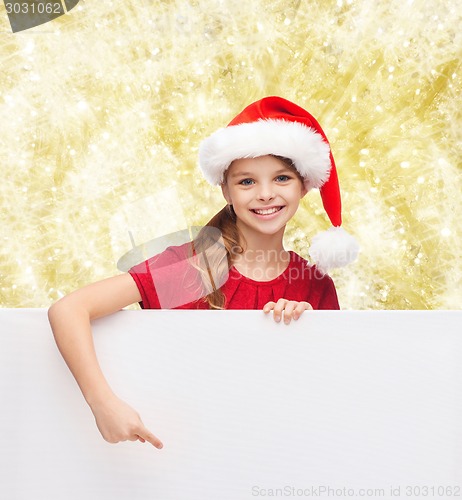 Image of girl in santa helper hat with blank white board