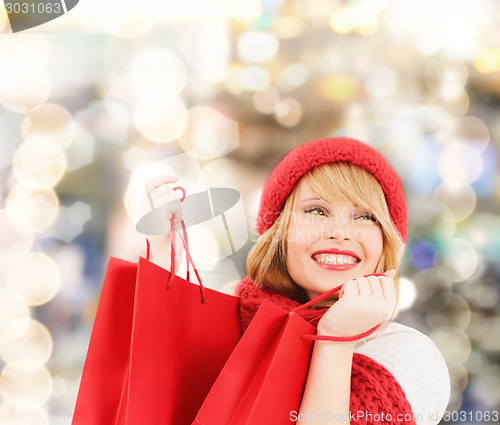 Image of smiling young woman with shopping bags