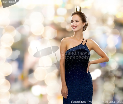 Image of smiling woman in evening dress wearing crown