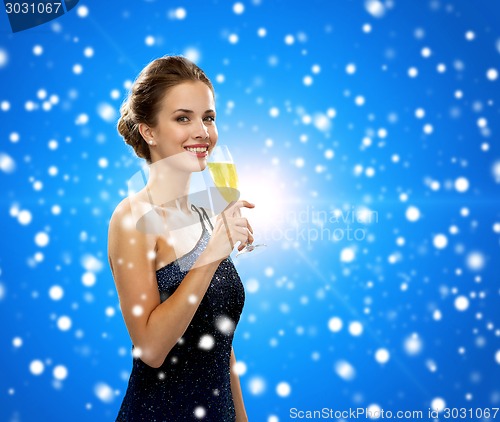 Image of smiling woman holding glass of sparkling wine