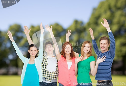 Image of group of smiling students waving hands