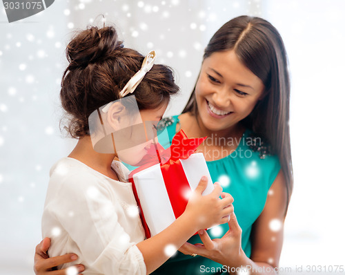 Image of happy mother and child girl with gift box