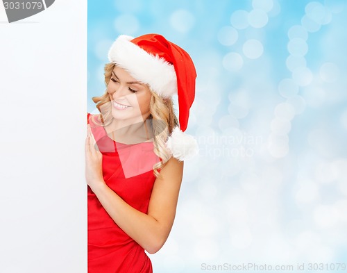 Image of smiling young woman in santa hat with white board