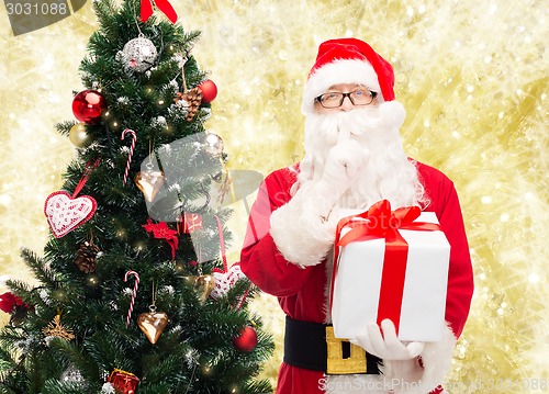 Image of man in costume of santa claus with gift box