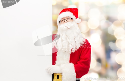 Image of man in costume of santa claus with billboard