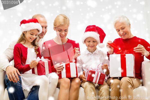 Image of smiling family with gifts at home