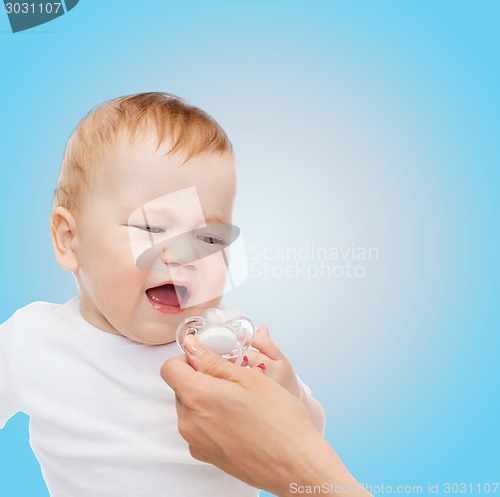 Image of crying baby with dummy