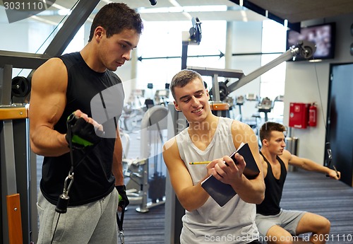 Image of men exercising on gym machine