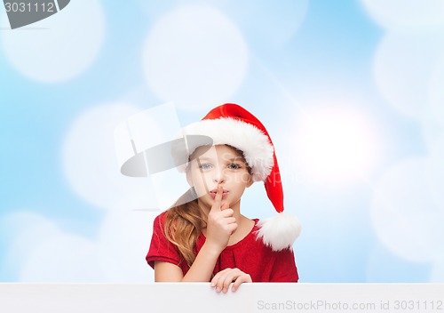 Image of smiling little girl in santa helper hat