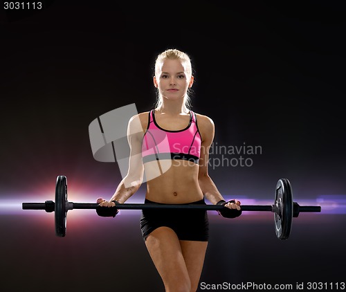 Image of sporty woman exercising with barbell