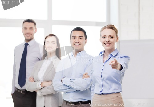 Image of businesswoman in office pointing finger at you